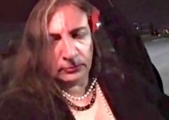 Horny mature crossdresser plays with a stick in public at night