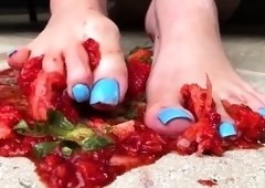 Dominatrix crushing and squeezing strawberries with her feet