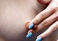 Aroused girl loves pinching her hard nipples while masturbating